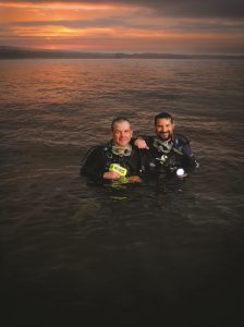 Richard and William posing in the river while diving.