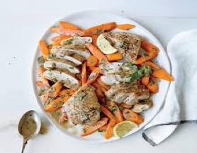 Chicken and carrots with lemon butter sauce on a white plate