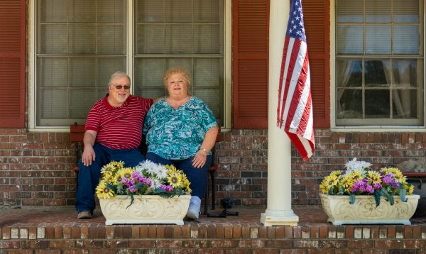 Patient Debra Allen and her husband Ed, on the front porch of their brick home in St. Matthews, SC.