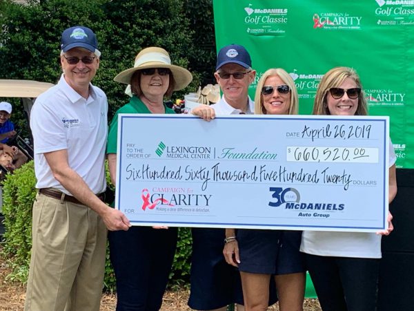 Five people holding a check for $660,520 for Lexington Medical Center Foundation's Campaign for Clarity