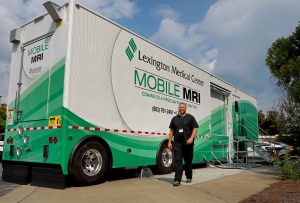 Man standing in front of Lexington Medical Center's Mobile MRI unit