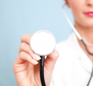 A doctor holding up a stethoscope.