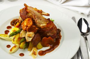 A plate full of fancy meat over pasta.