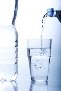 Water pouring from a bottle into a glass.