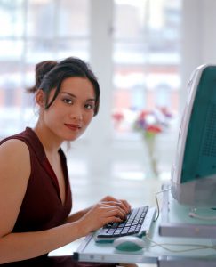 A woman looking for information on a computer.