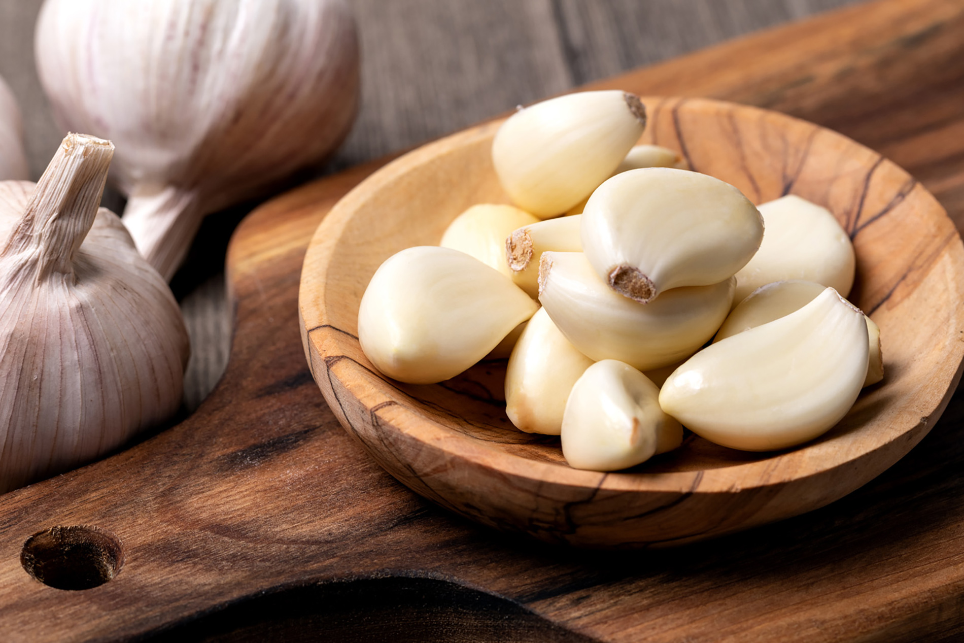 Garlic cloves in wooden bowl