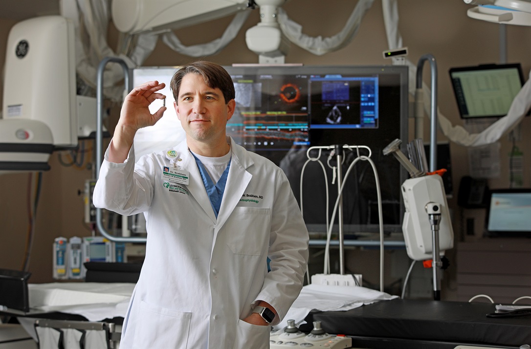 Cardiologist holding a pacemaker device