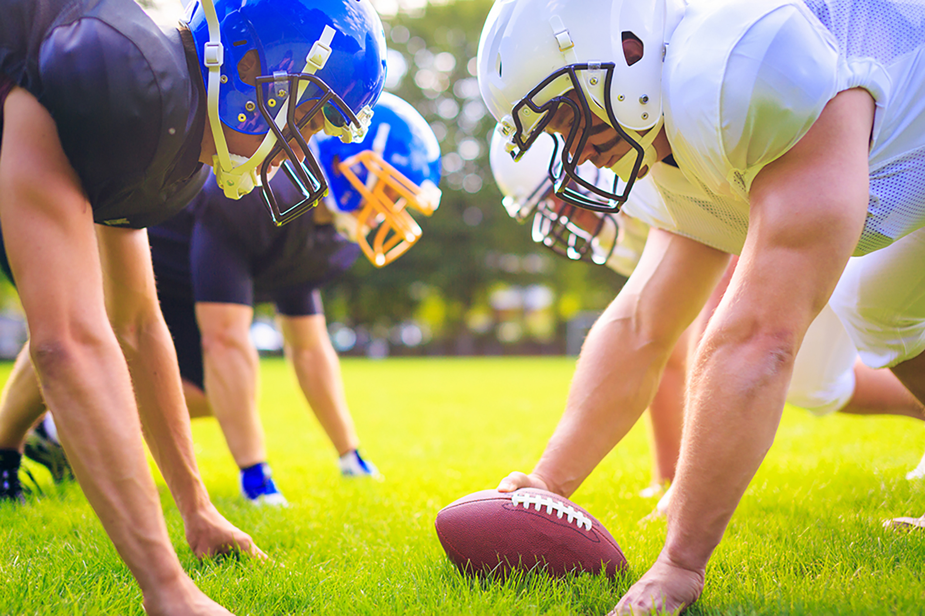 Football players at line of scrimmage