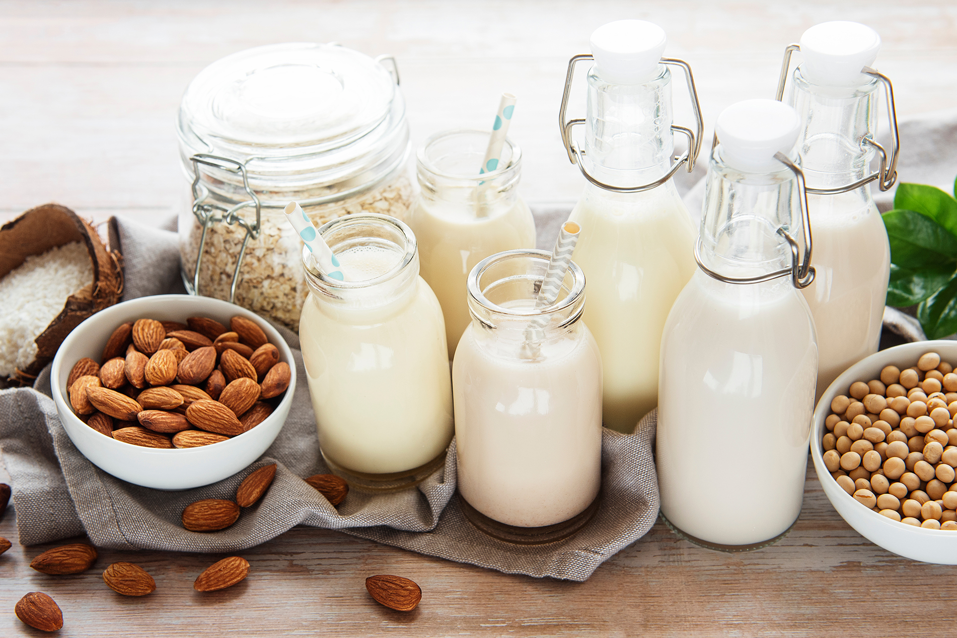 Various types of milks in glasses and pitchers