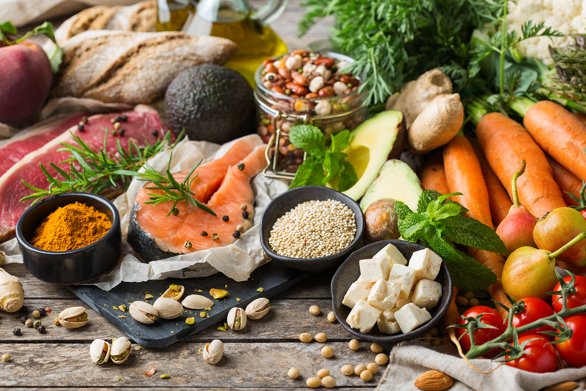 Display of grains, fruits, vegetables, cheese, salmon, chicken on a tray