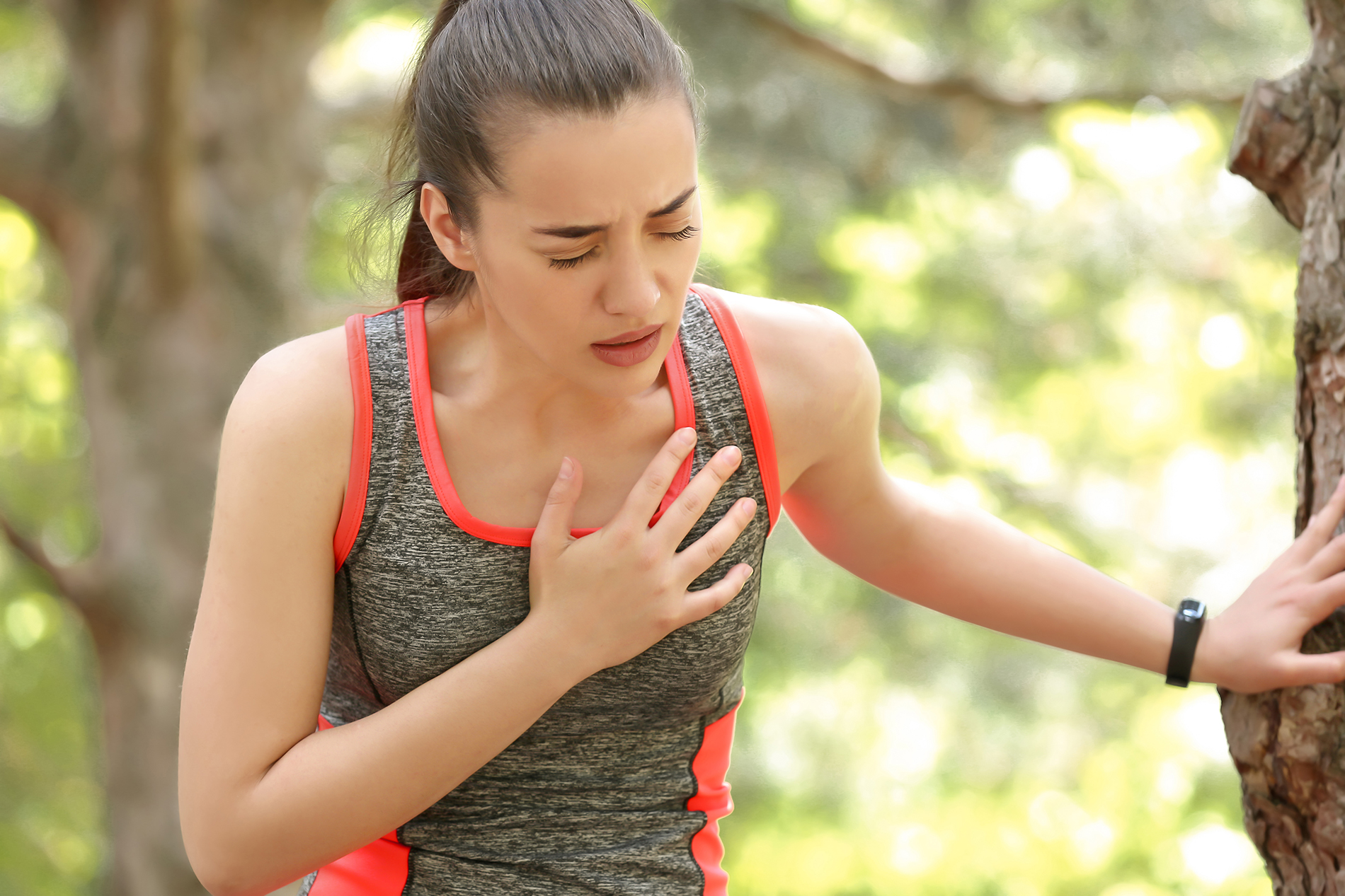 Woman with chest pain in park