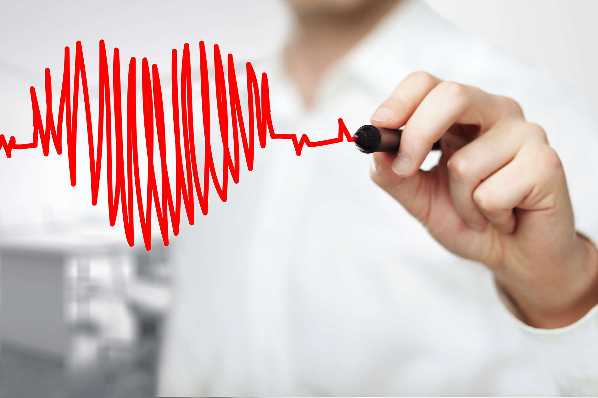 Doctor drawing an abstract heart with red marker