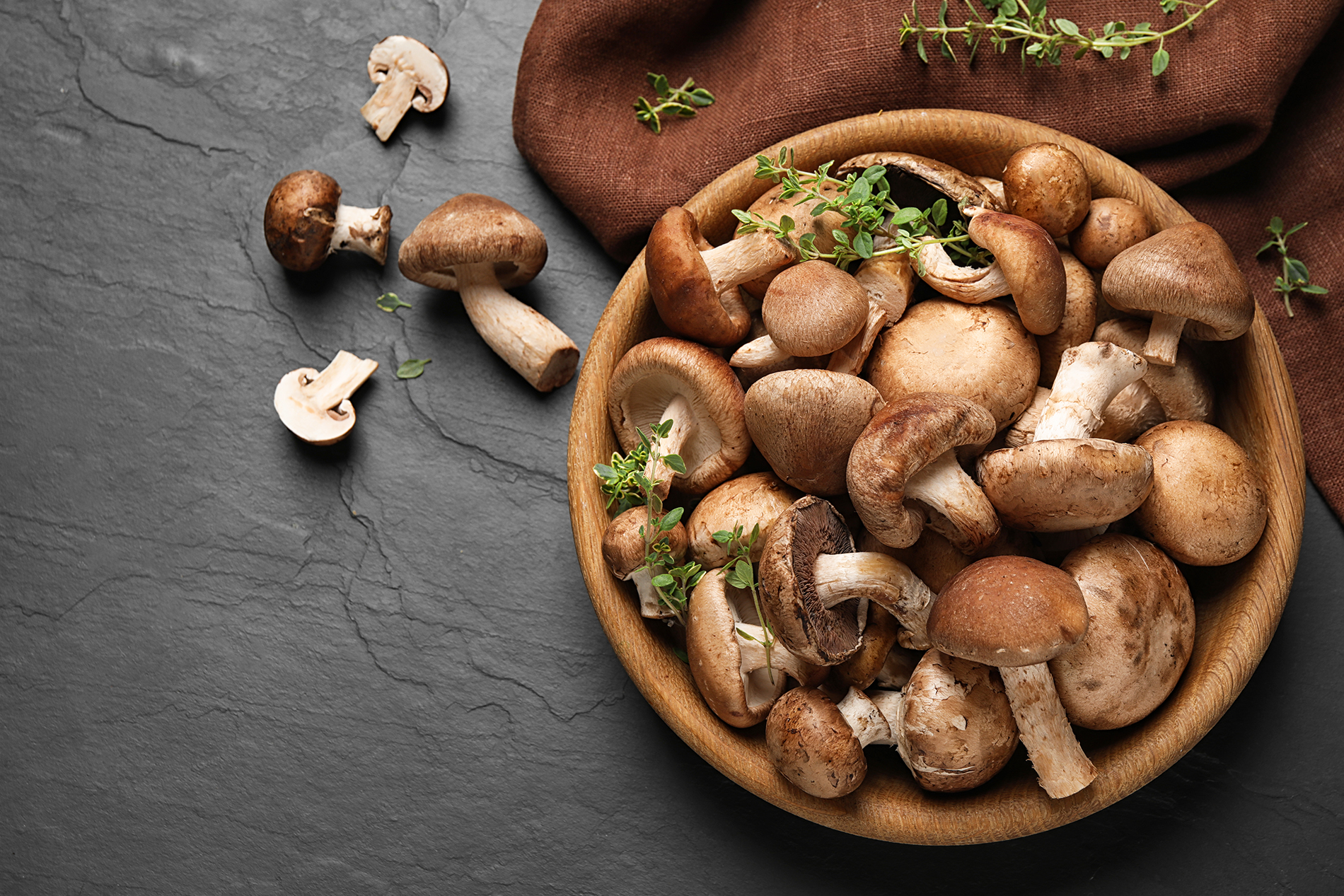 fresh mushrooms in wooden bowl on table