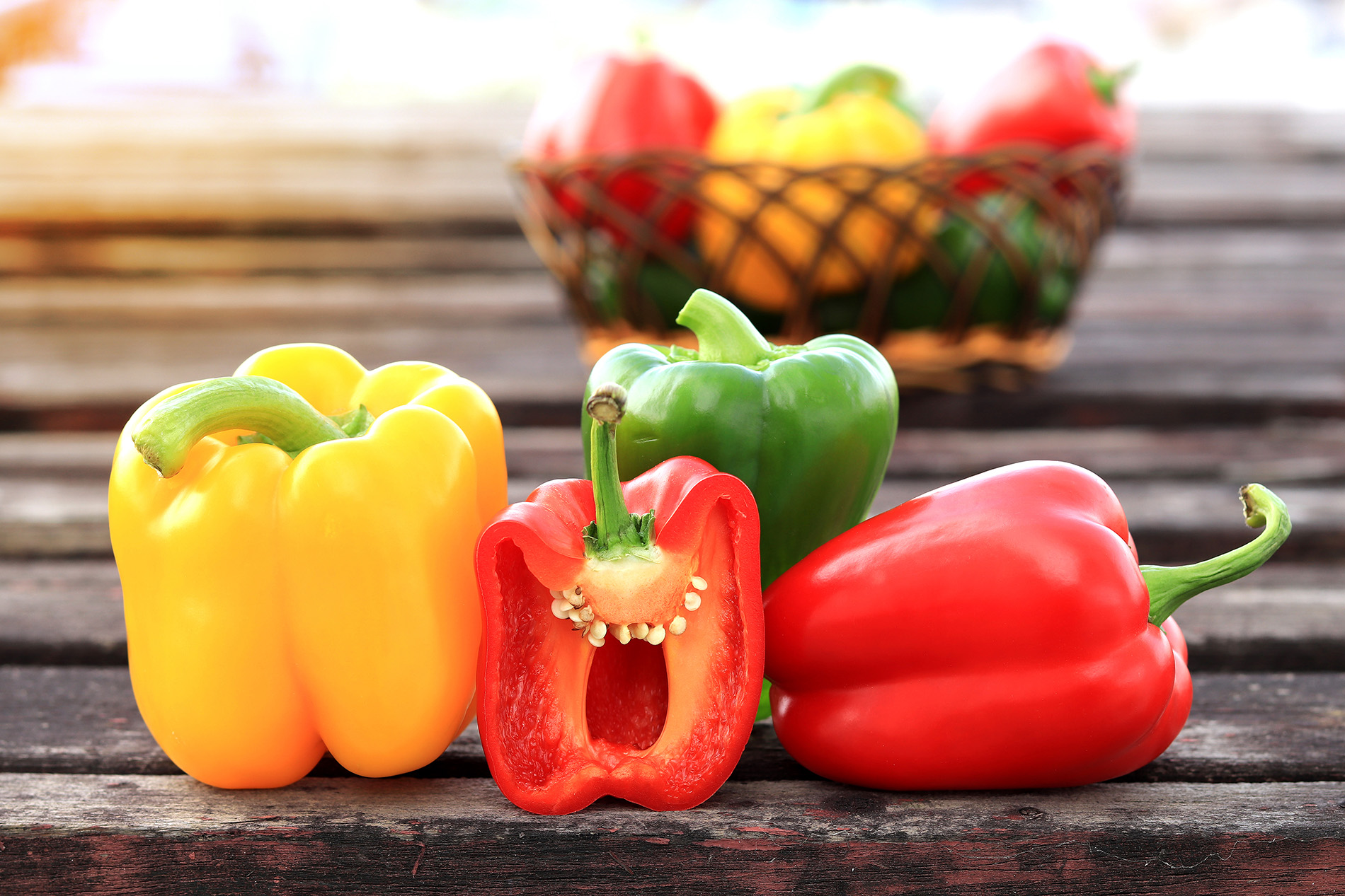 red, yellow and green bell peppers on table