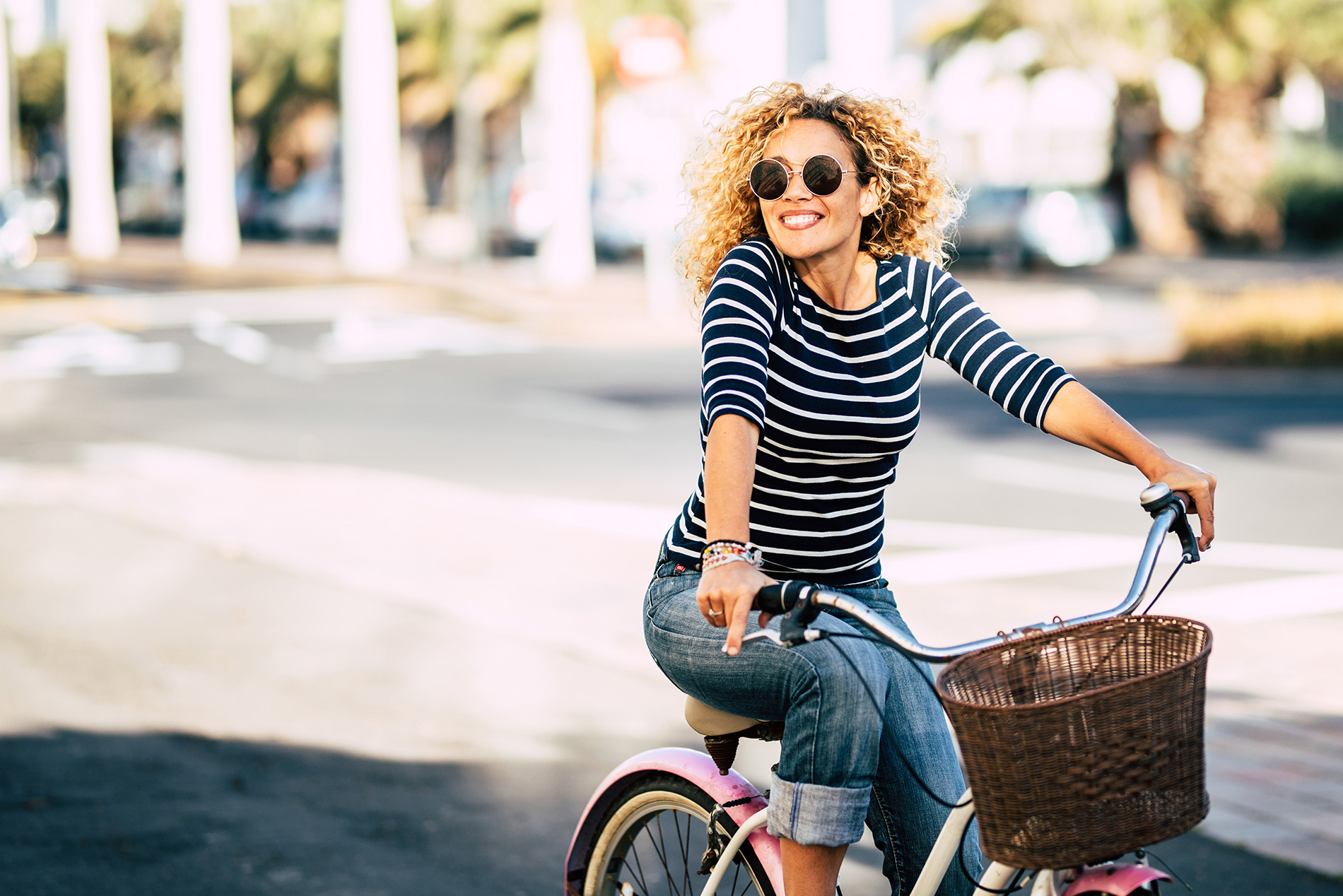 Smiling middle aged woman riding a bicycle