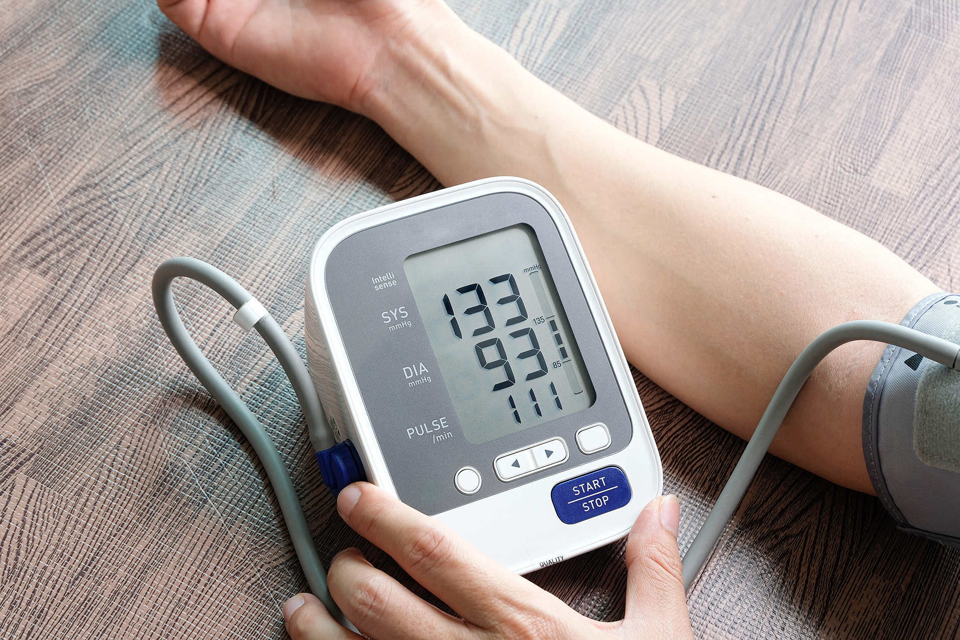 woman taking blood pressure with high reading