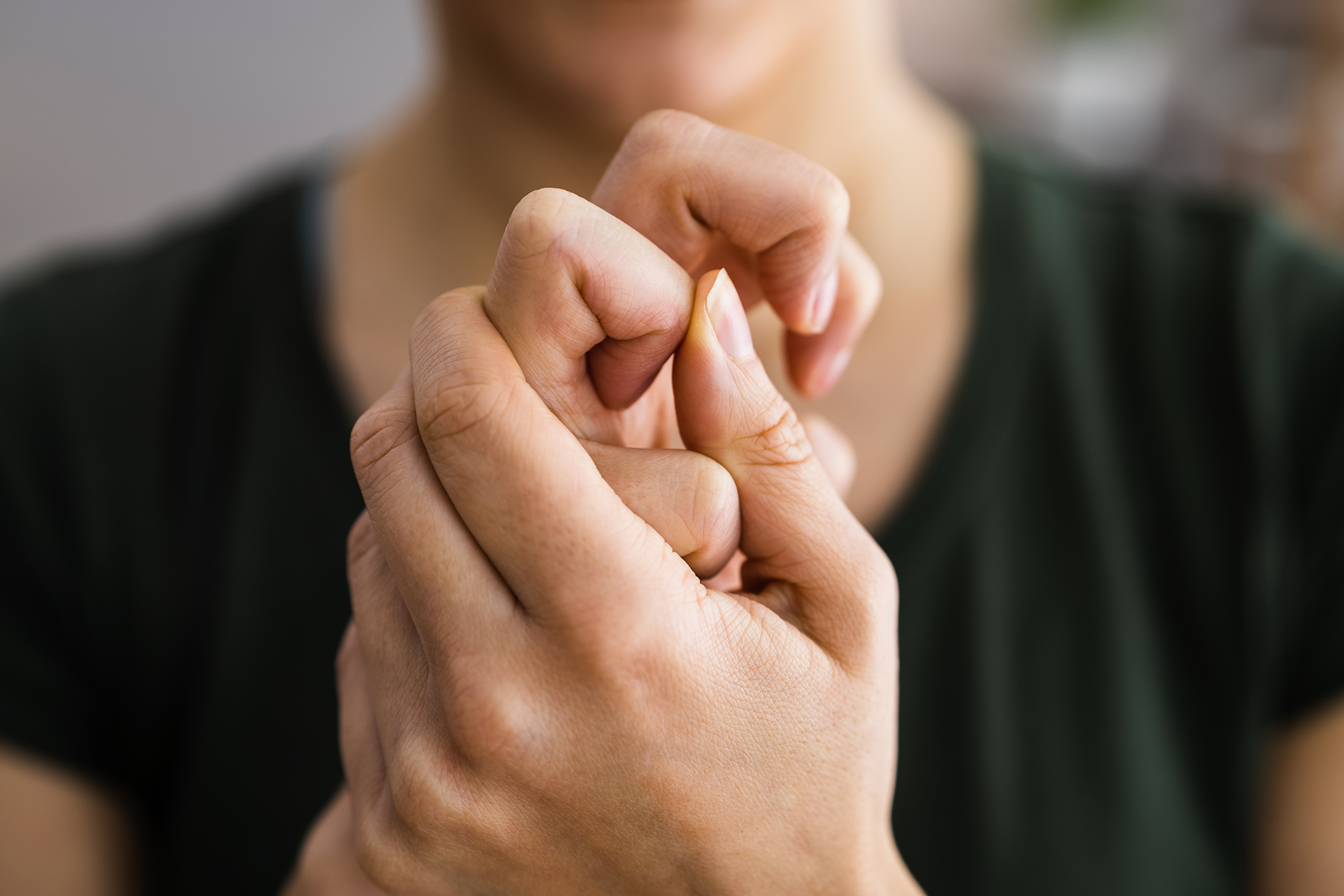 Woman in black shirt cracking her knuckles