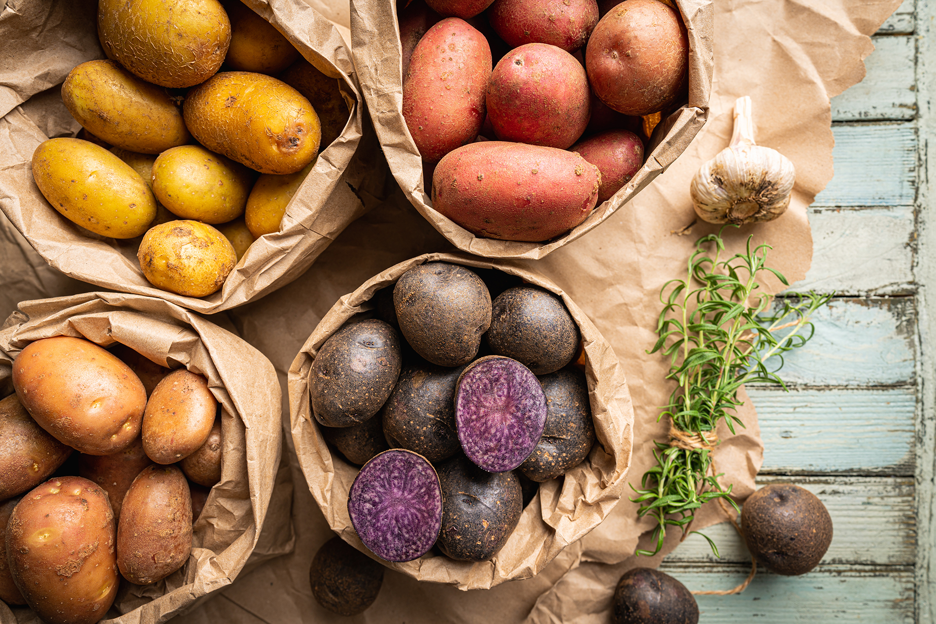 White, red, yellow and purple potatoes in baskets