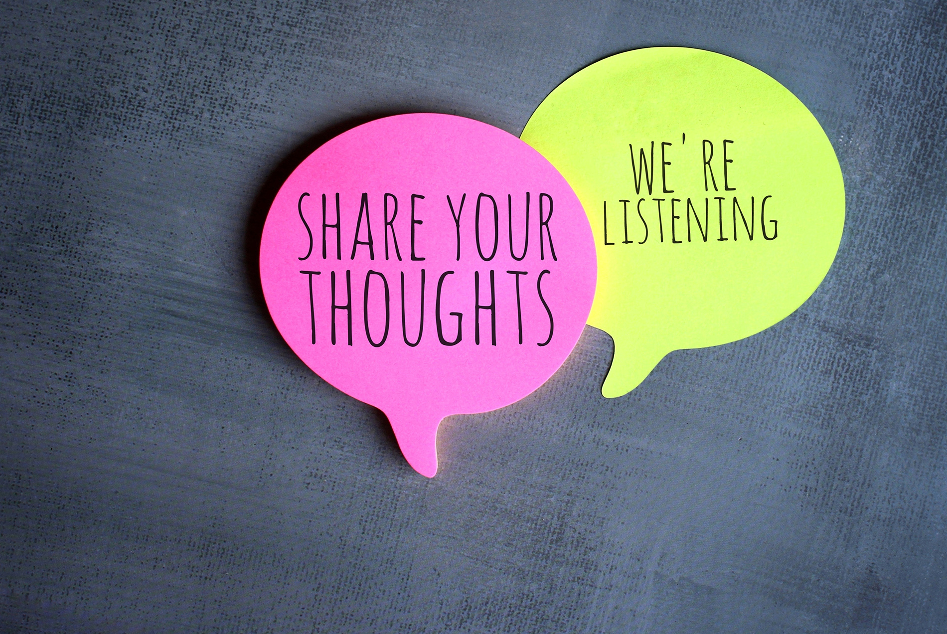 Sticky notes that say "share your thoughts" and "we're listening"