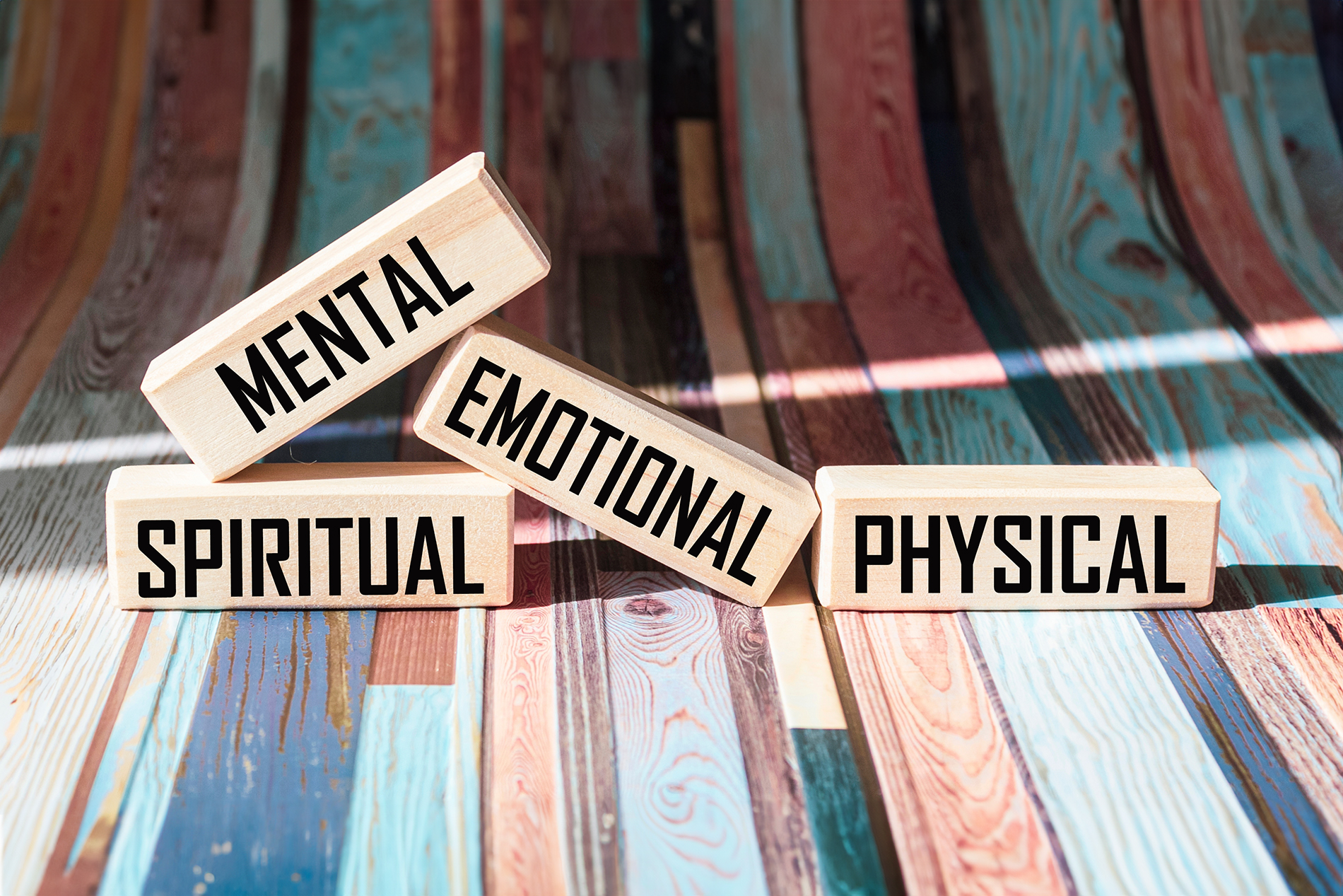 Wooden signs that read spiritual, mental, physical and emotional