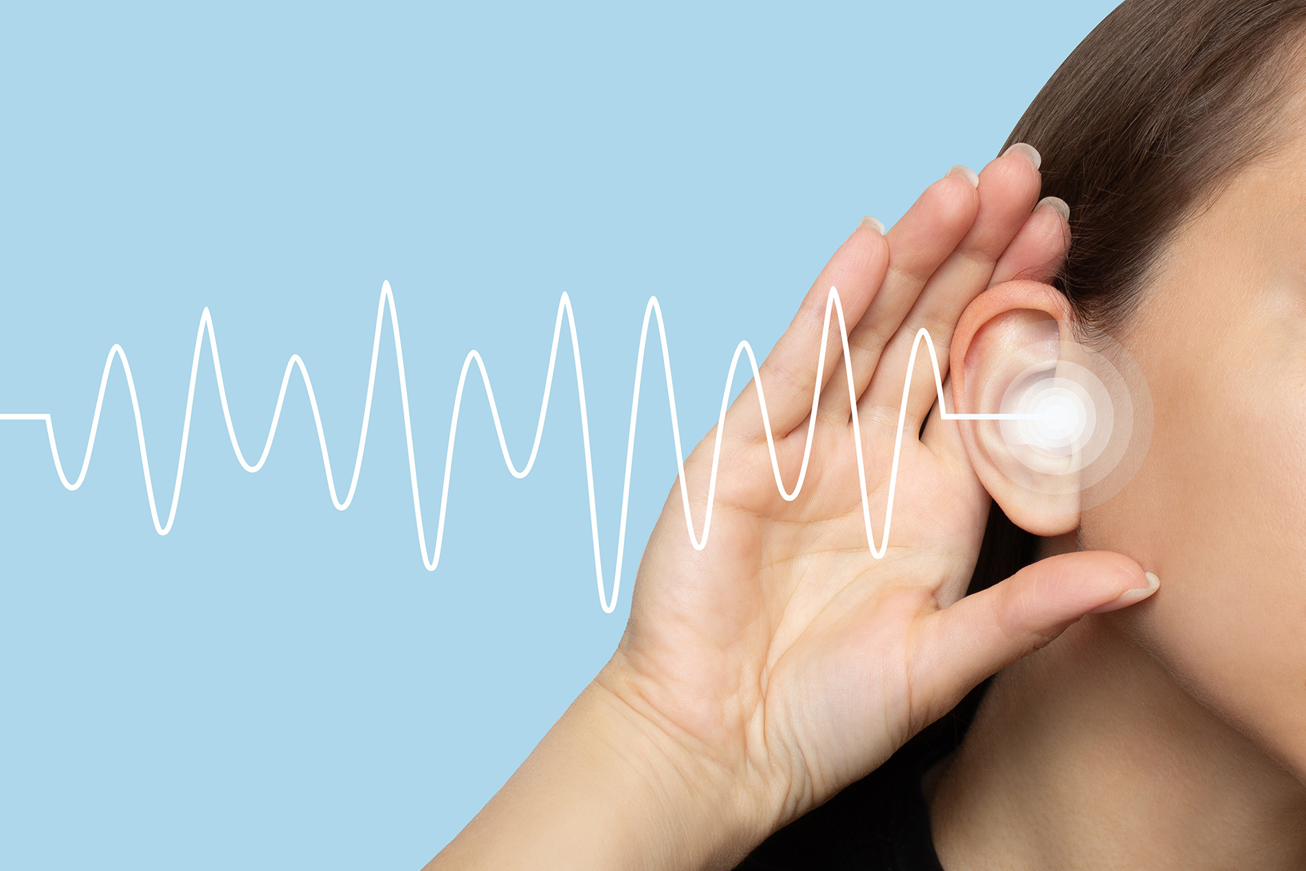 Young woman touching her ears with graphic representation of sound waves coming from ear