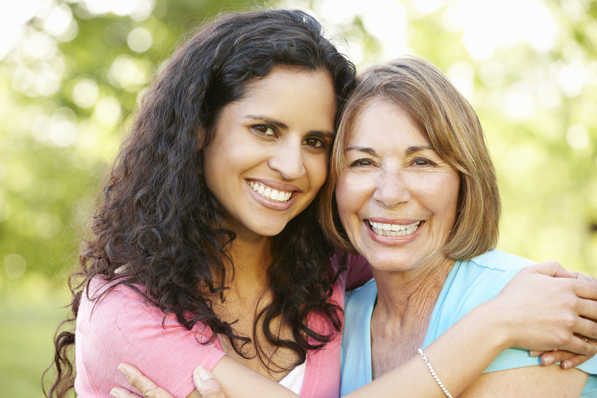 Hispanic woman hugging her mother