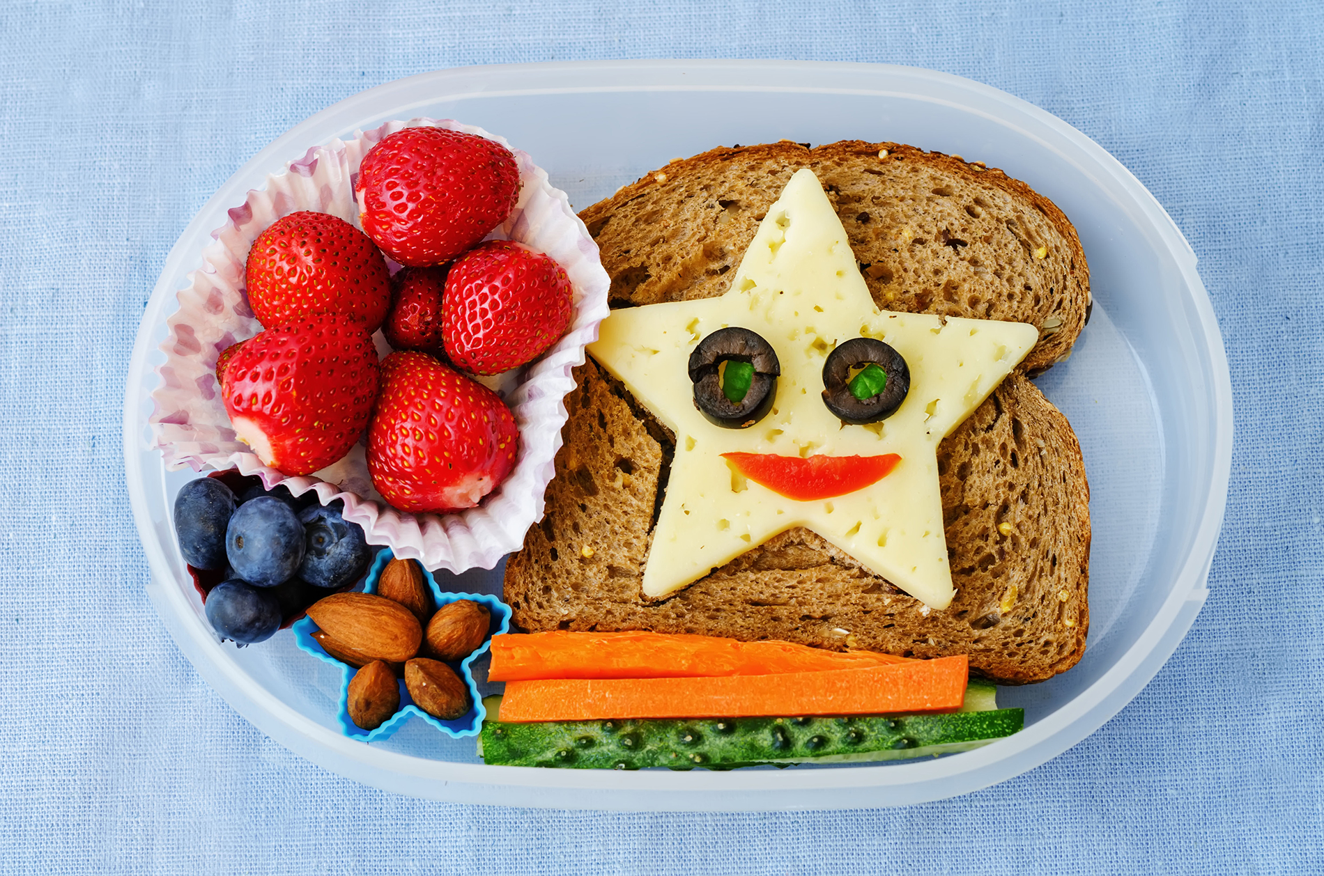 Whole wheat sandwich, cheese , fruit and vegetables in lunch box