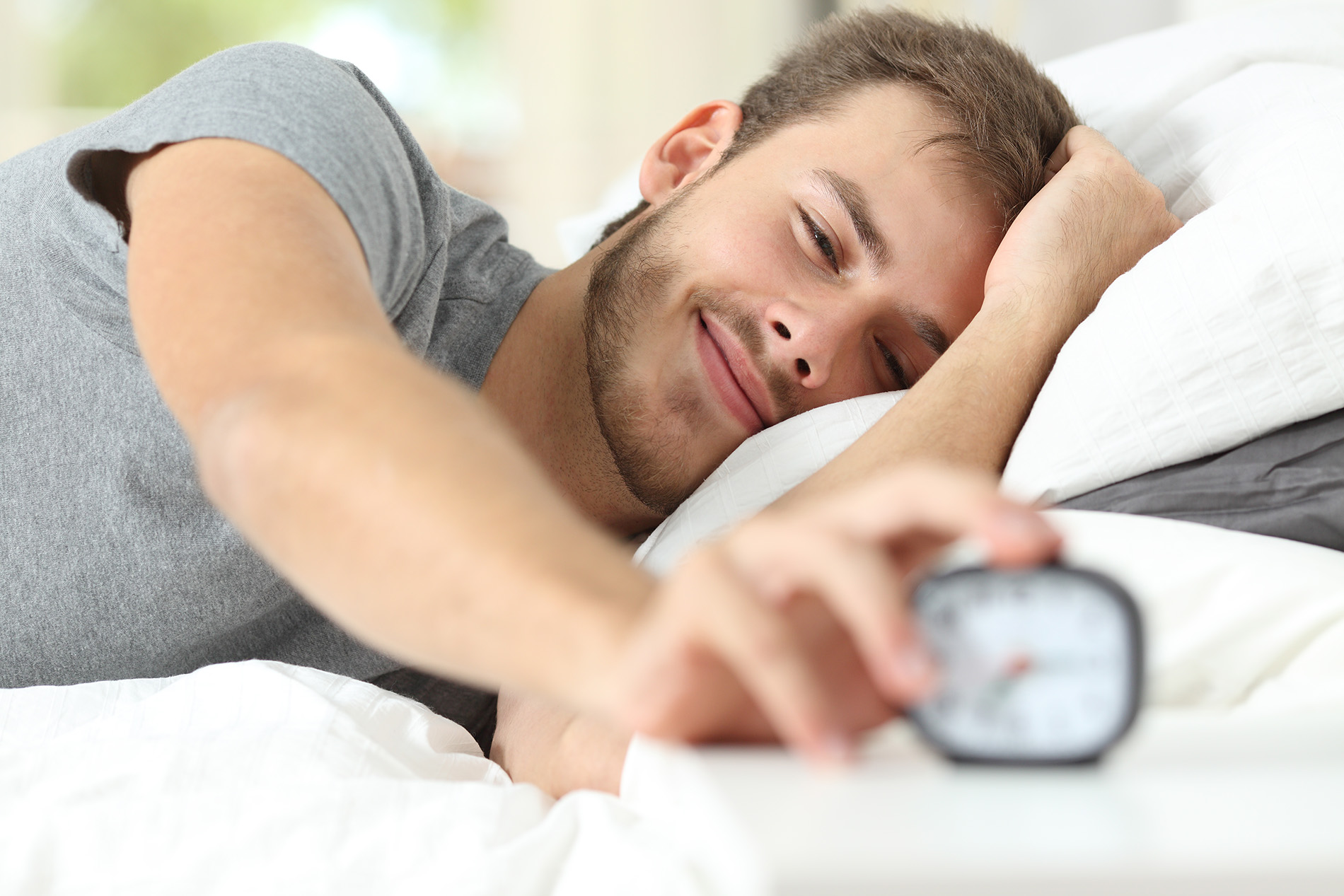 Young man waking up refreshed