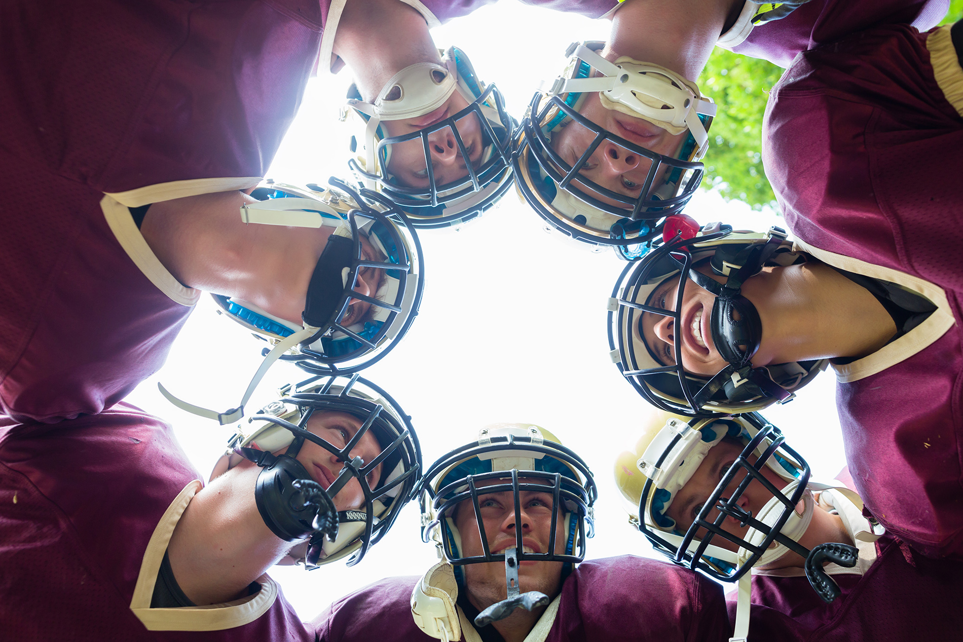 High school football players in huddle