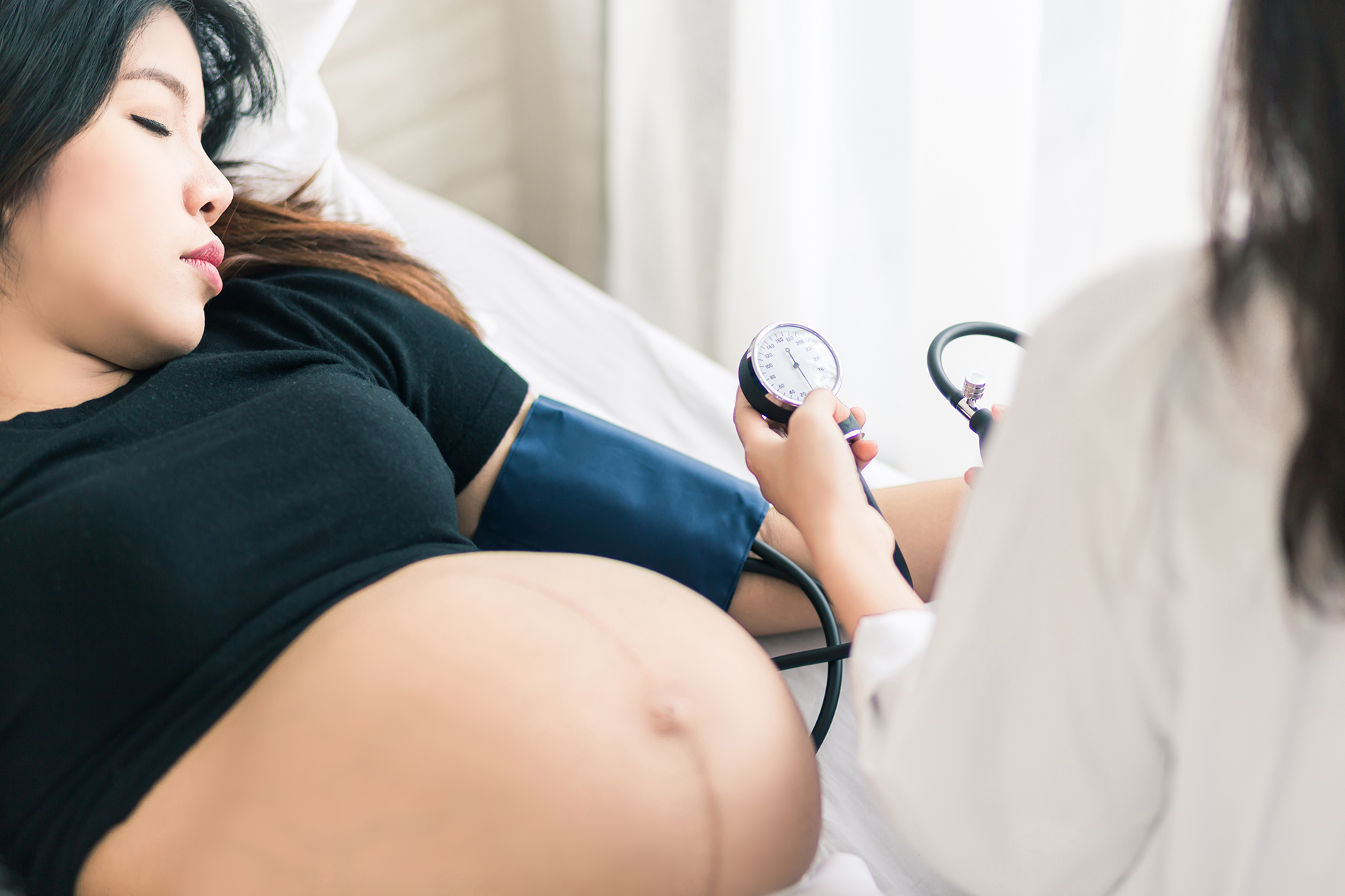 Pregnant women getting blood pressure checked
