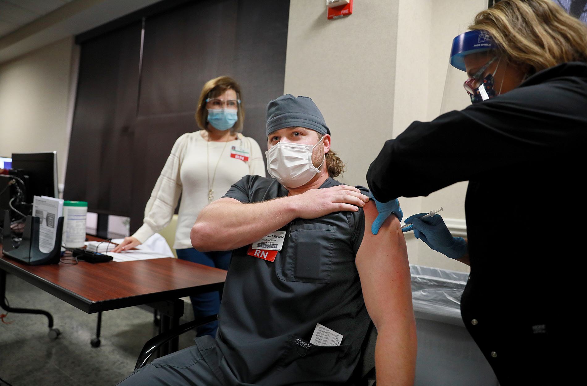 Nurse Ethan Rucker receiving COVID-19 vaccine