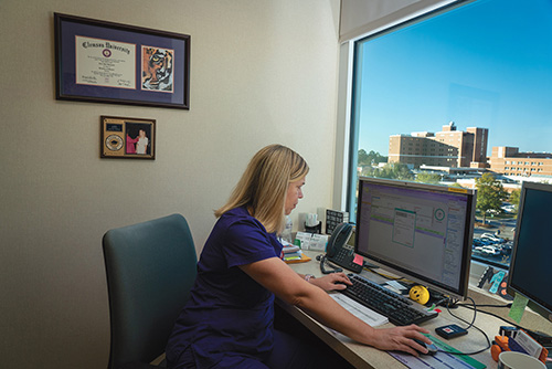 Alice Green at her desk