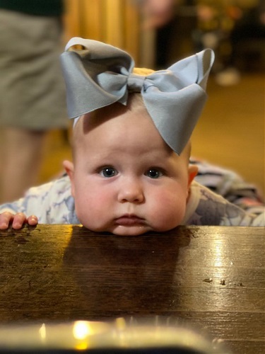 Baby resting her face on table