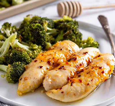 Baked orange chicken and broccoli on plate