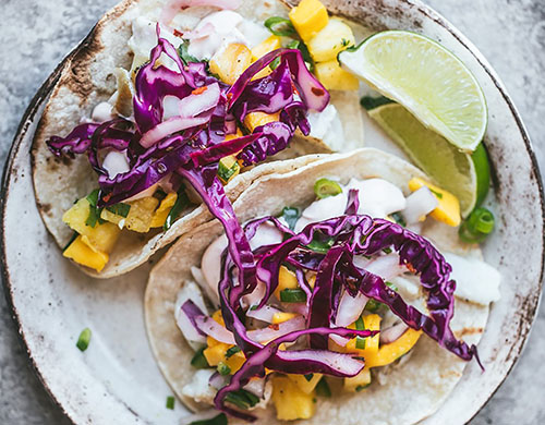 Fish tacos with mango slaw on plate