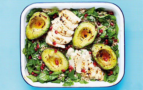 Baked avocado and chicken salad on white tray