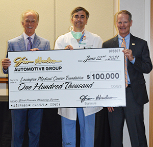 Jim Hudson presenting check to Dr. Leonardi and Ted Nissen