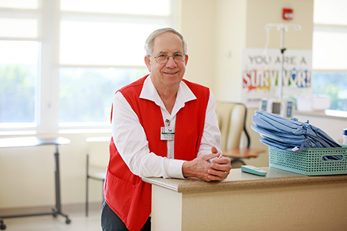 Ted Winegardner smiling at desk in infusion center