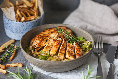 Rosemary chicken on bed of cooked cabbage