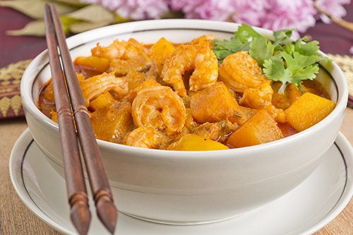 Pumpkin Coconut Red Curry with Shrimp in brown bowl