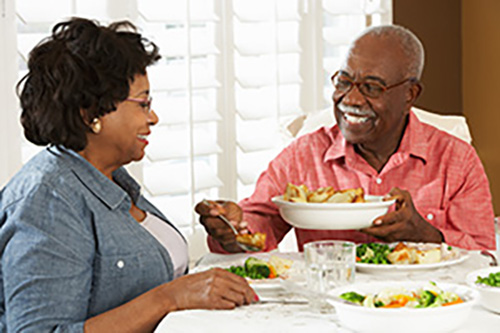 Couple eating healthy meal at home