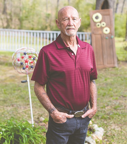 Steve Melton standing outside his home