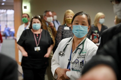 Lexington Medical Center employees watching nurse receive first COVID-19 vaccination