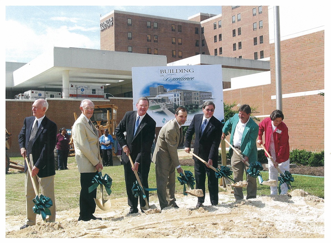 Hospital leaders shoveling dirt at groundbreaking