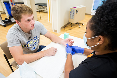 Occupational therapist working with young patient with hand injury