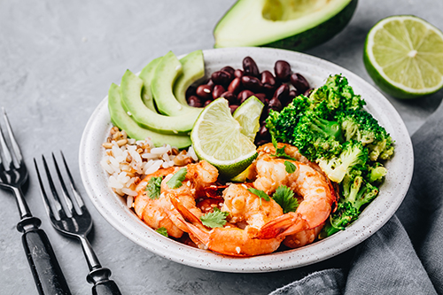 Avocado Burrito Bowl with Shrimp on table